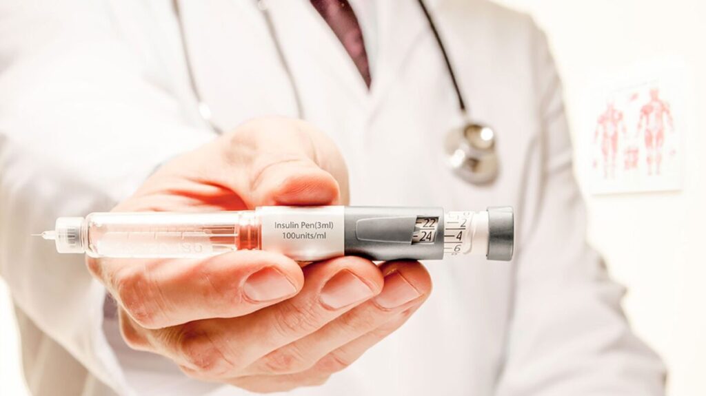 Image of pharmacist holding an insulin pen.