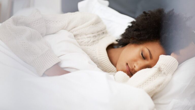 Image of woman sleeping in bed.