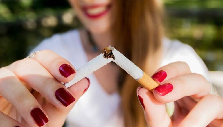 Image of person holding two cigarettes together.
